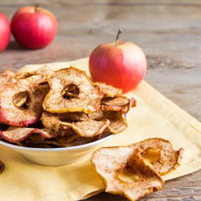 Organic apple cinnamon chips in bowl - healthy vegan vegetarian fruit snack or ingredient for cooking